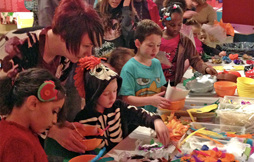 Children and adults making Halloween masks